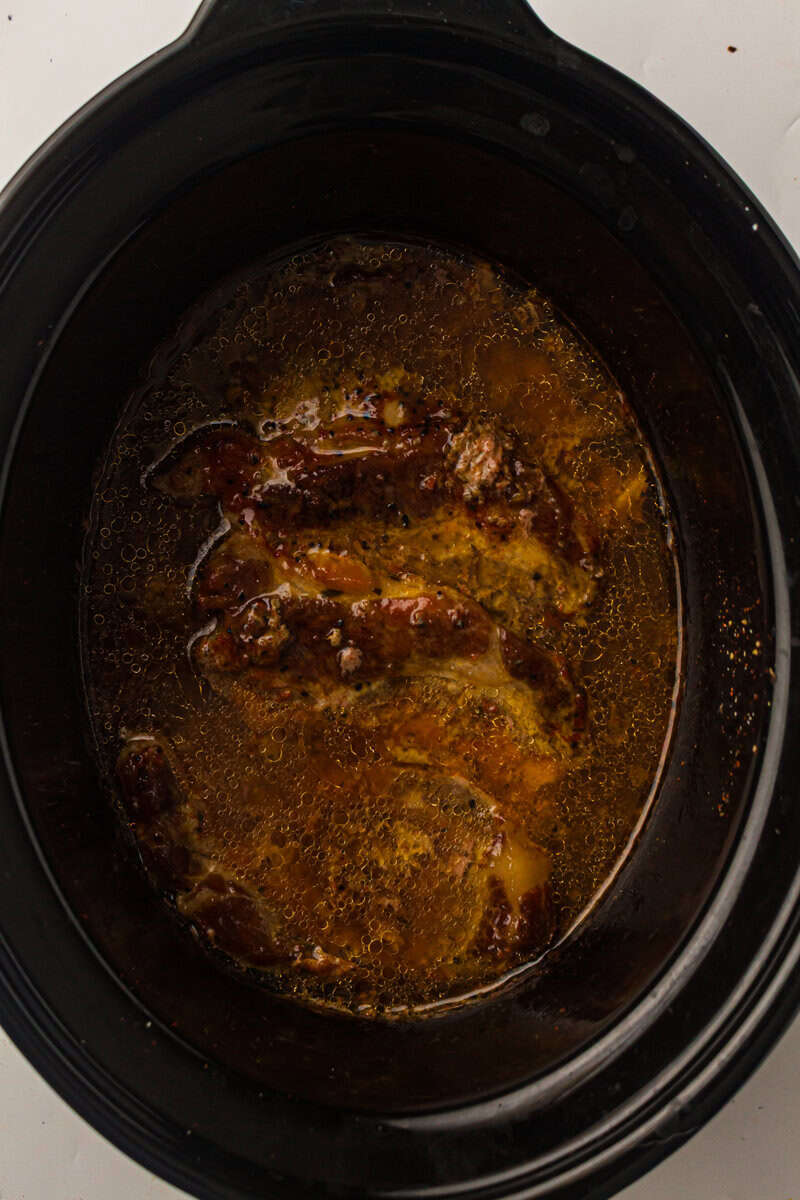 broth pork and sauce in the slow cooker