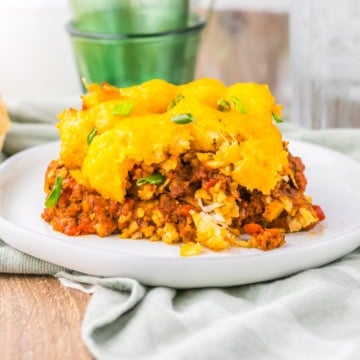 Slow Cooker Chili Cheese Tatertot Casserole slice on a white plate