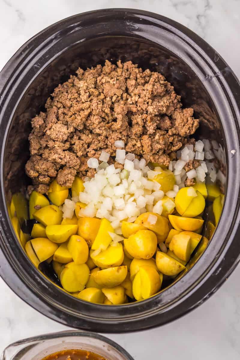 onions, potatoes and beef in slow cooker