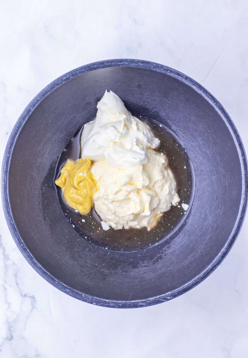 mayo and mustard dressing a bowl for Steakhouse Potato Salad