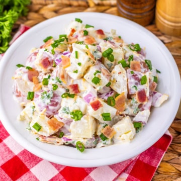 steakhouse potato salad on a white plate with red checkered tablecloth