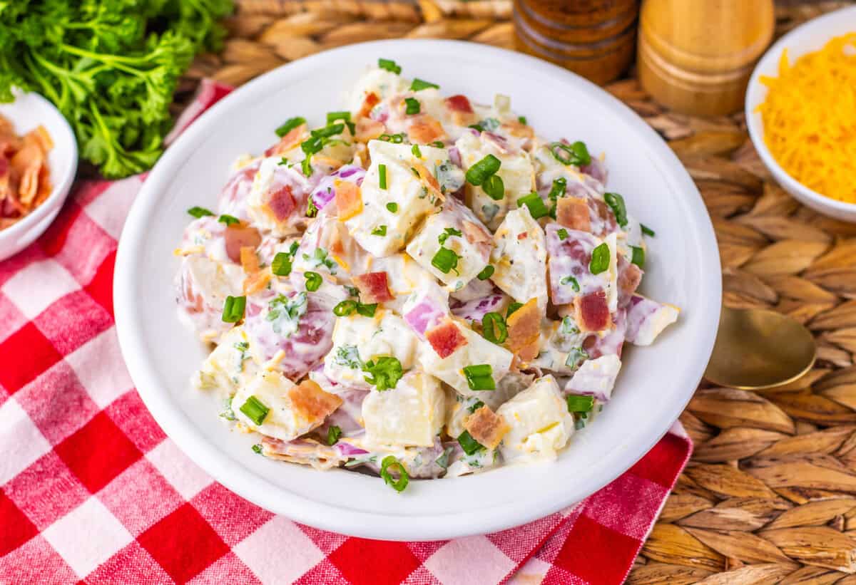 steakhouse potato salad on a white plate with red checkered tablecloth