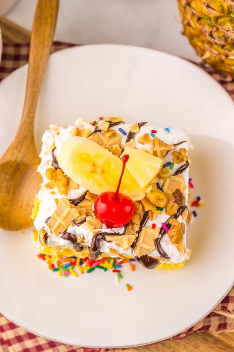 slice of banana split poke cake