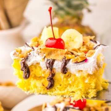 piece of banana split poke cake on a spatula