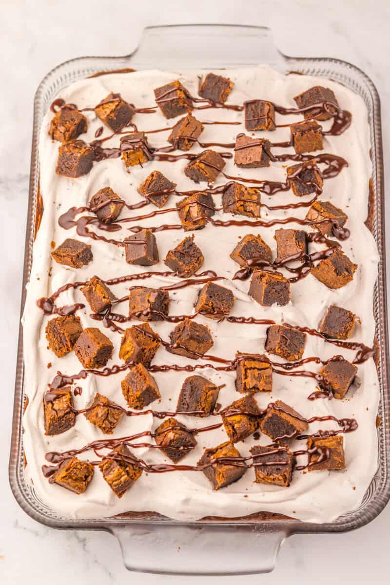 poke cake with brownie pieces on top