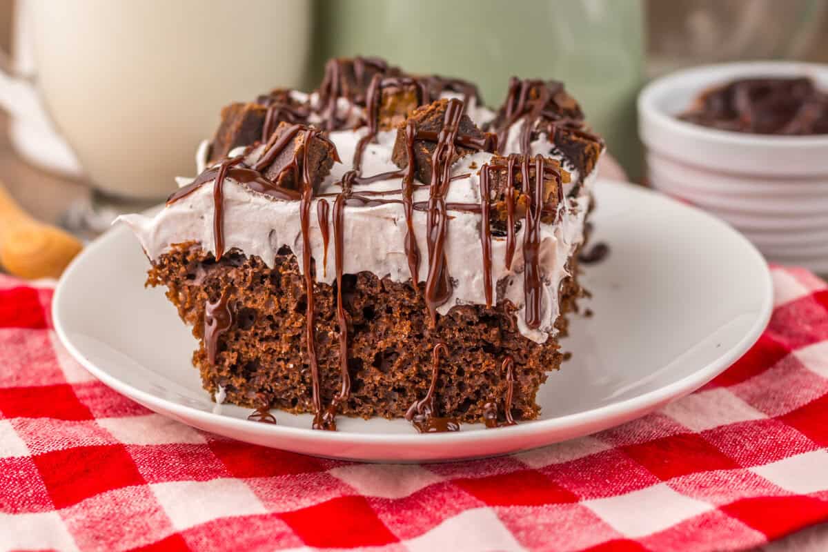 piece of choxolate poke cake on a plate