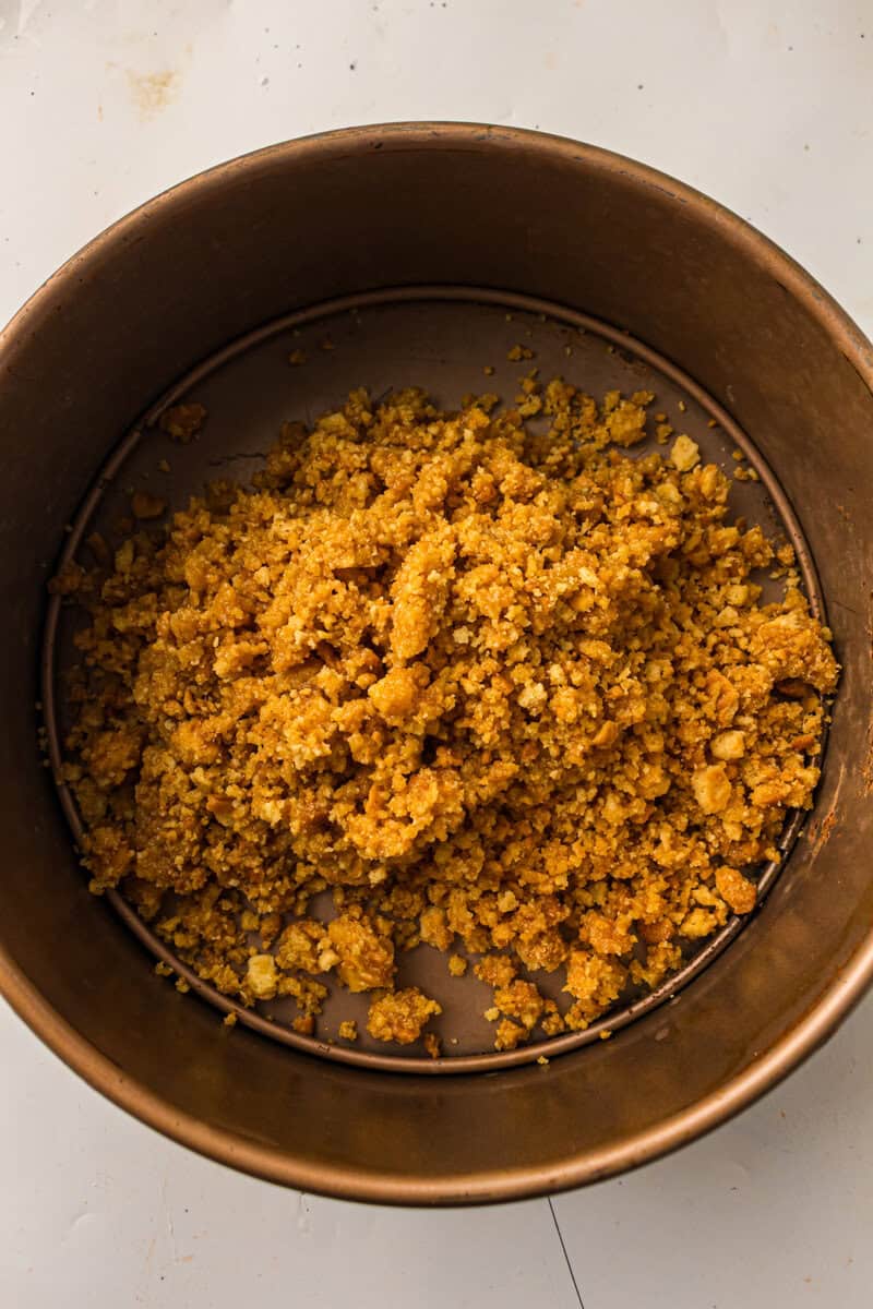 graham crackers crumbs with butter in a springform pan