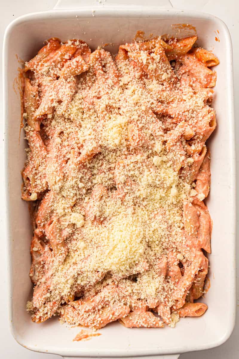 pasta in casserole dish topped with parmesan cheese