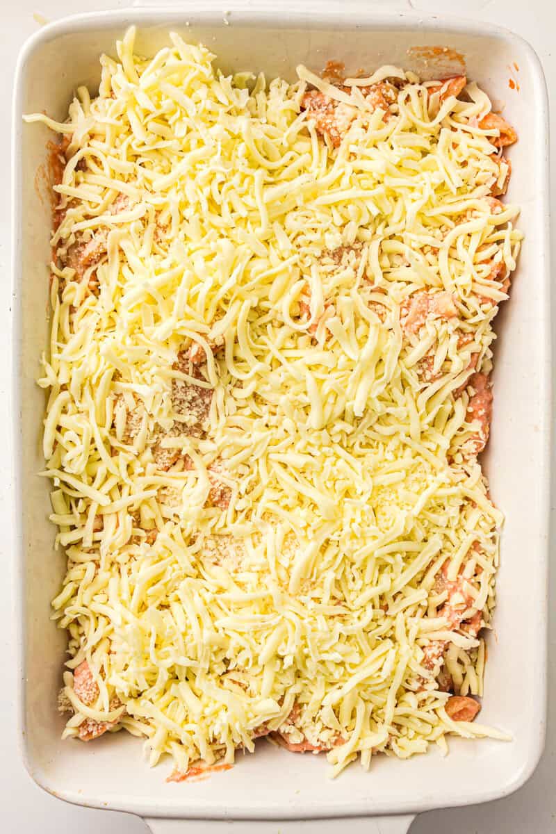 mozarella cheese on top of pasta in casserole dish