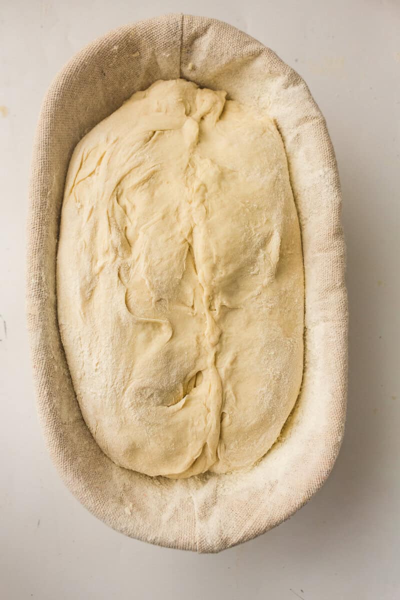 floured proofing basket with dough in it