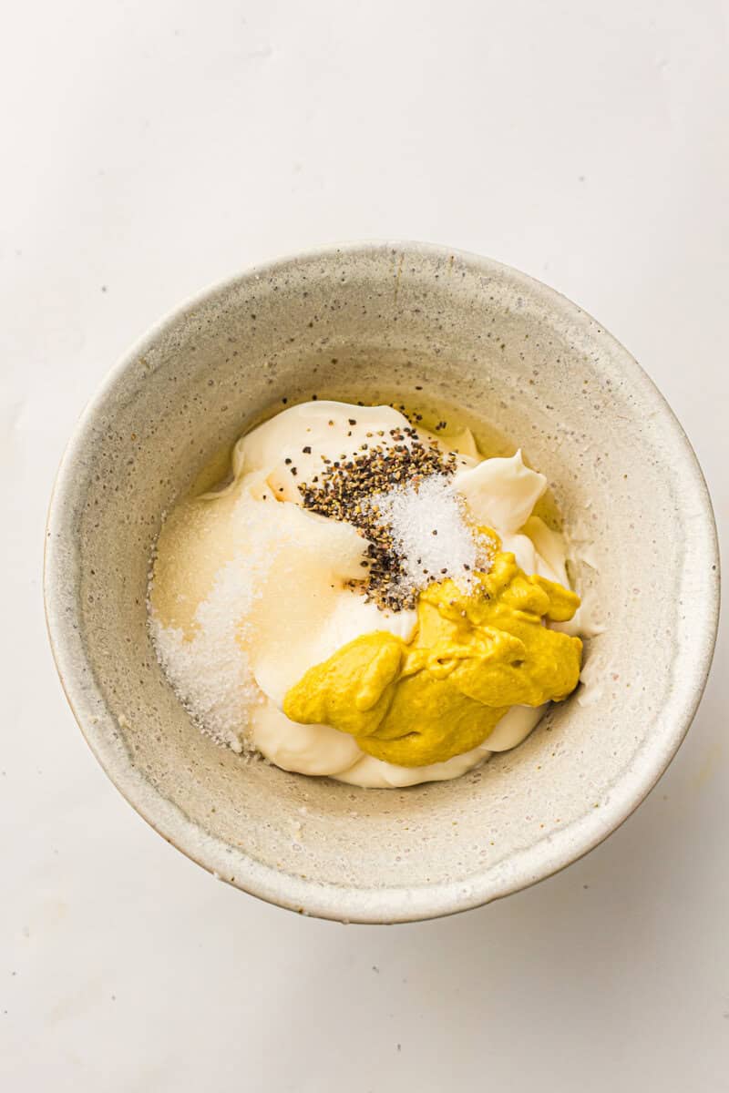 mustard, mayoannaise and herbs in a small bowl