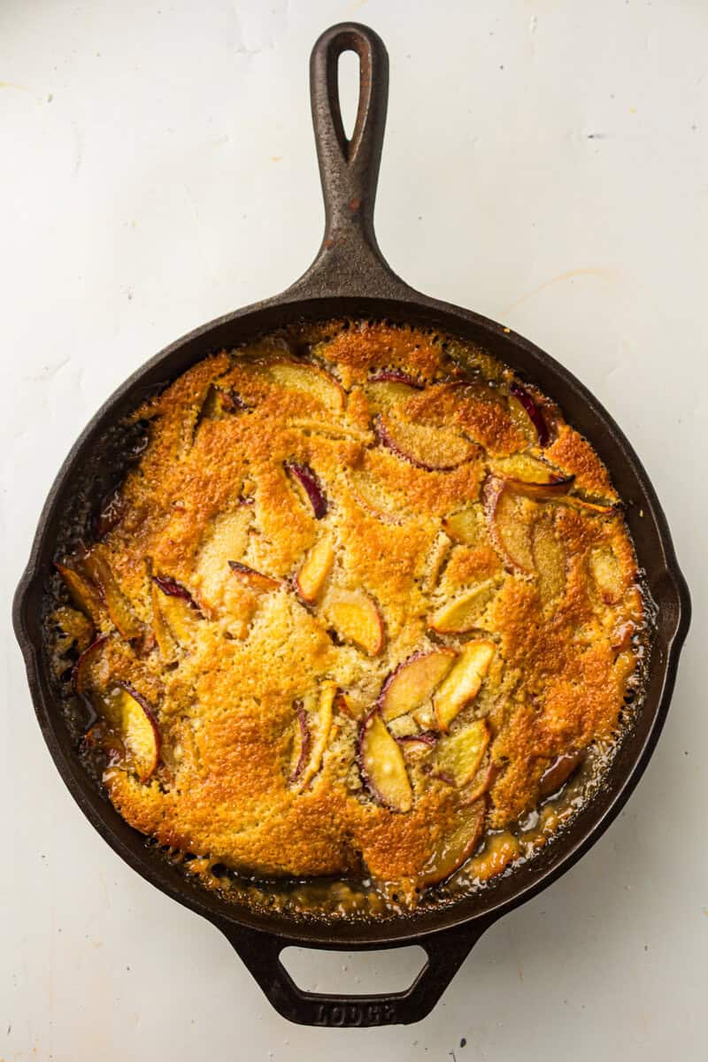 baked peach cobbler in a cast iron skiillet