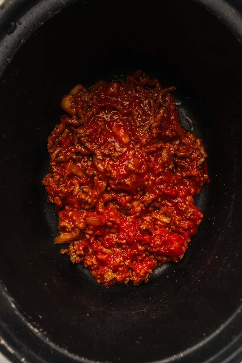 meat sauce in bottom of slow cooker for first layer