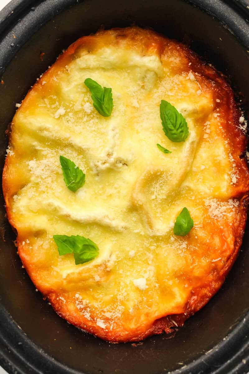finished lasagna with parmesan cheese and basil