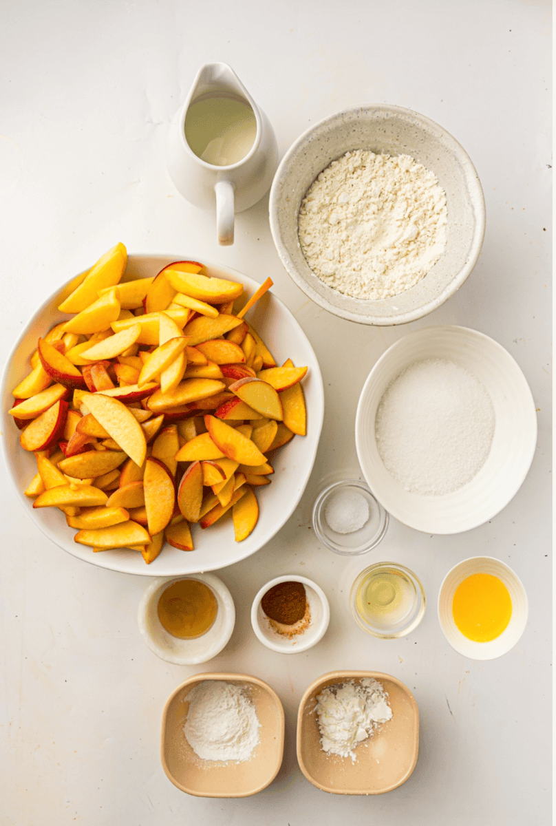 peaches, flour, sugar and ingredients for peach cobbler