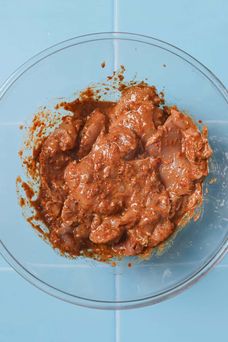 chicken thighs in a bowl with marinade