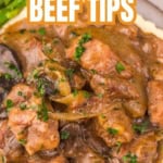 Copycat Texas Roadhouse Beef Tips in rich gravy served over creamy mashed potatoes, garnished with chopped parsley, with asparagus in the background. Perfectly made in a slow cooker for tender, flavor-packed results. Text reads “Texas Roadhouse Beef Tips.”.
