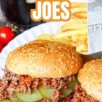Two sloppy joe sandwiches with pickles on a white plate, served with French fries; a glass of dark soda is in the background. Text overlay reads “Easy Sloppy Joes.” These homemade Sloppy Joes are the perfect comfort food for any occasion.