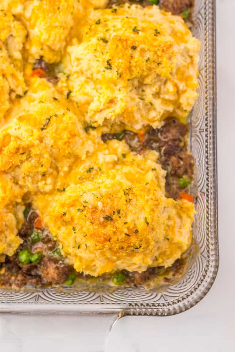 Cheddar Bay Biscuit casserole with ground beef in a clear glass baking dish.