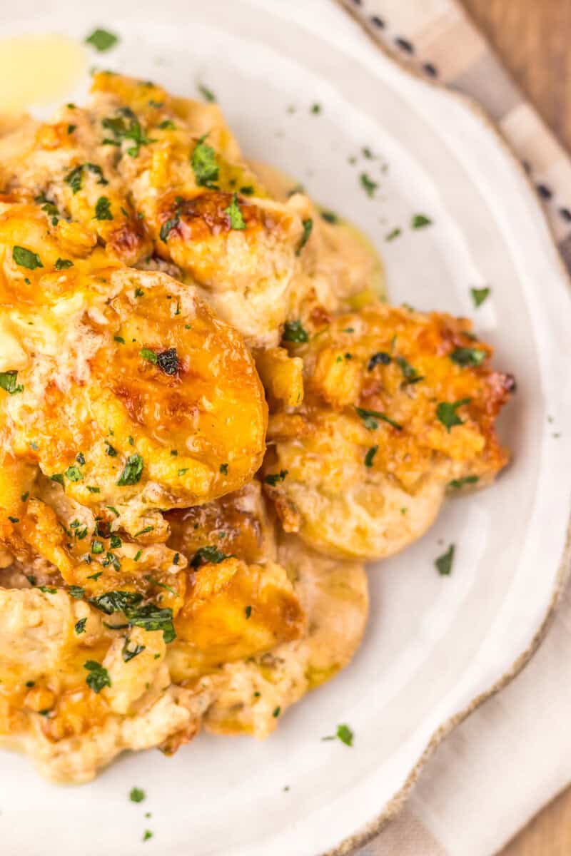 A serving of cheesy potato casserole on a white plate.