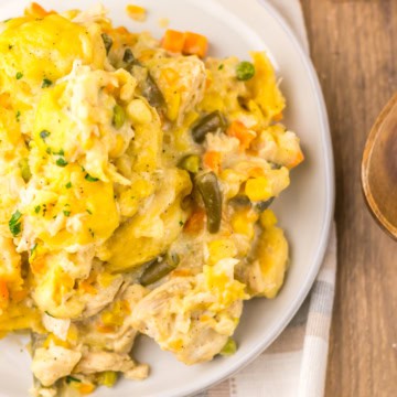 A serving of slow cooker chicken and dumplings on a white plate.
