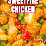 A close-up of Panda Express sweetfire chicken with breaded chicken, red bell peppers, onions, green onions, and sesame seeds in a flavorful sweet and spicy sauce.