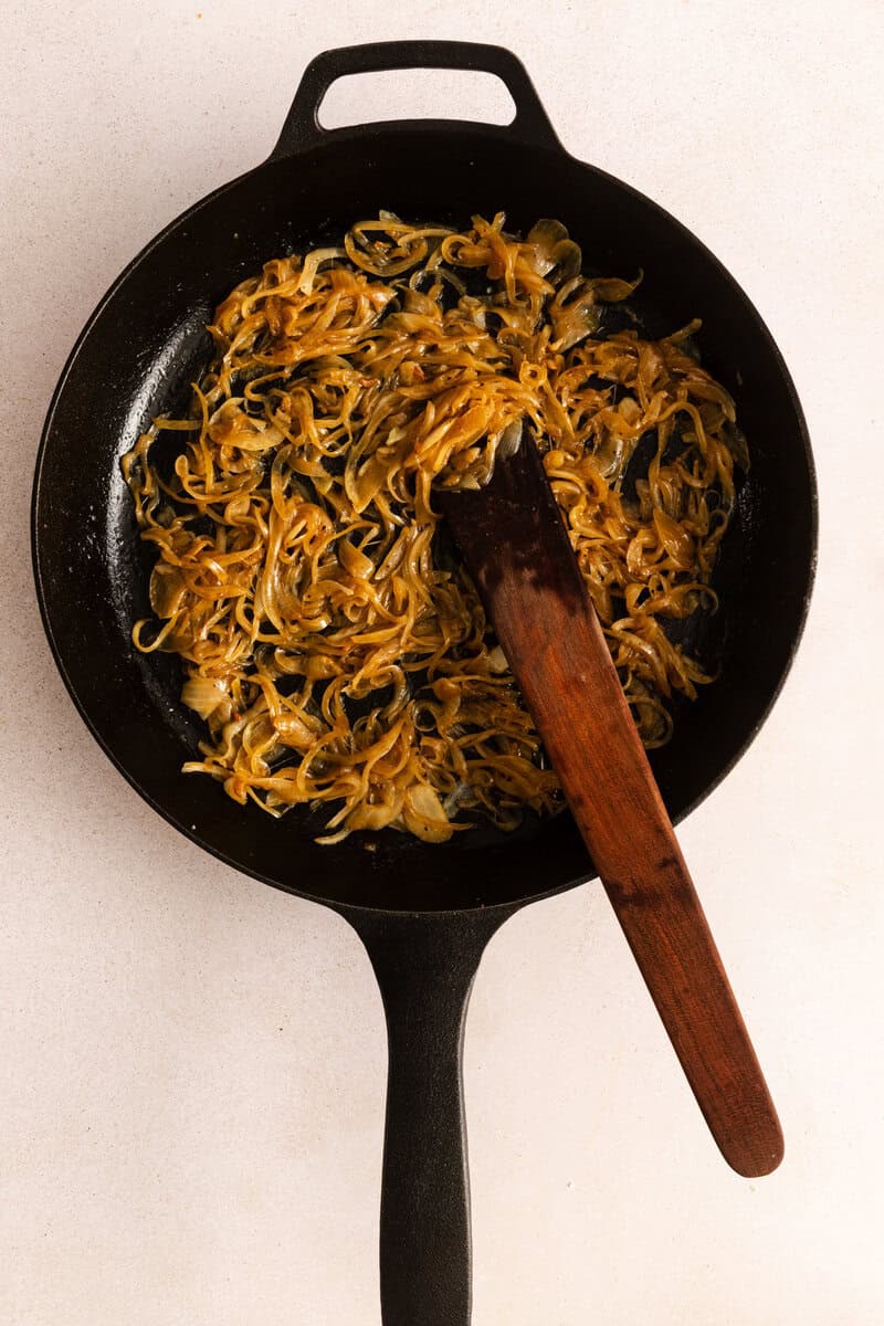Caramelized onions in a black cast iron skillet.